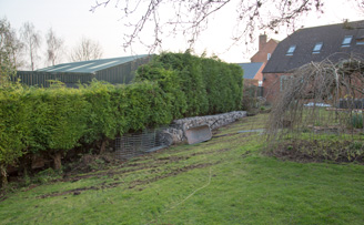 Retained Slope soakaway and water treatment plant using reclaimed concrete stone from driveway